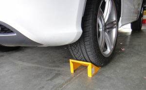 Place a wheel chock on the opposite side of the lifting point.
